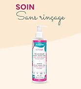 Un flacon pompe de traitement capillaire sans rinçage avec des éléments décoratifs bleu sarcelle et rose. Comprend le texte français « Soin Sans rinçage » (traitement sans rinçage)