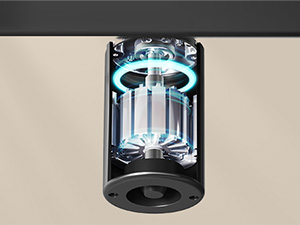 Vue rapprochée d'un appareil cylindrique dont les composants internes illuminés en bleu sont visibles à travers un boîtier transparent