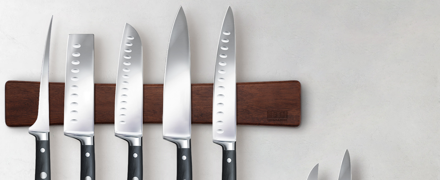 Porte-couteaux magnétique fixé au mur, présentant cinq couteaux de cuisine en acier inoxydable de différentes tailles avec des manches noirs.