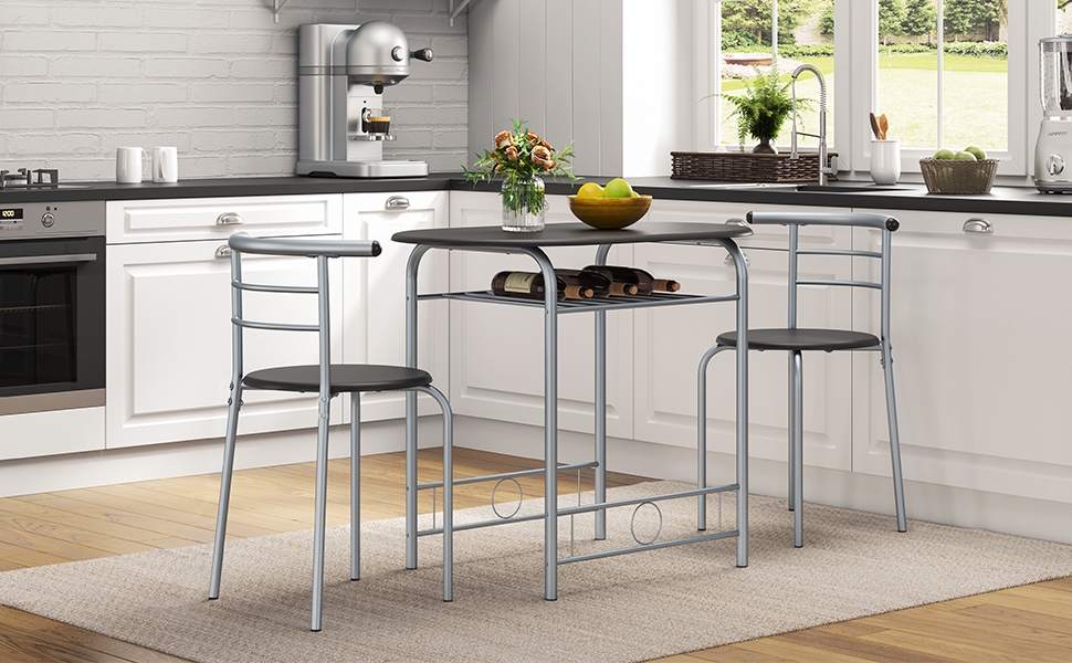 avec table ronde noire et deux tabourets assortis, présenté dans un décor de cuisine blanc moderne