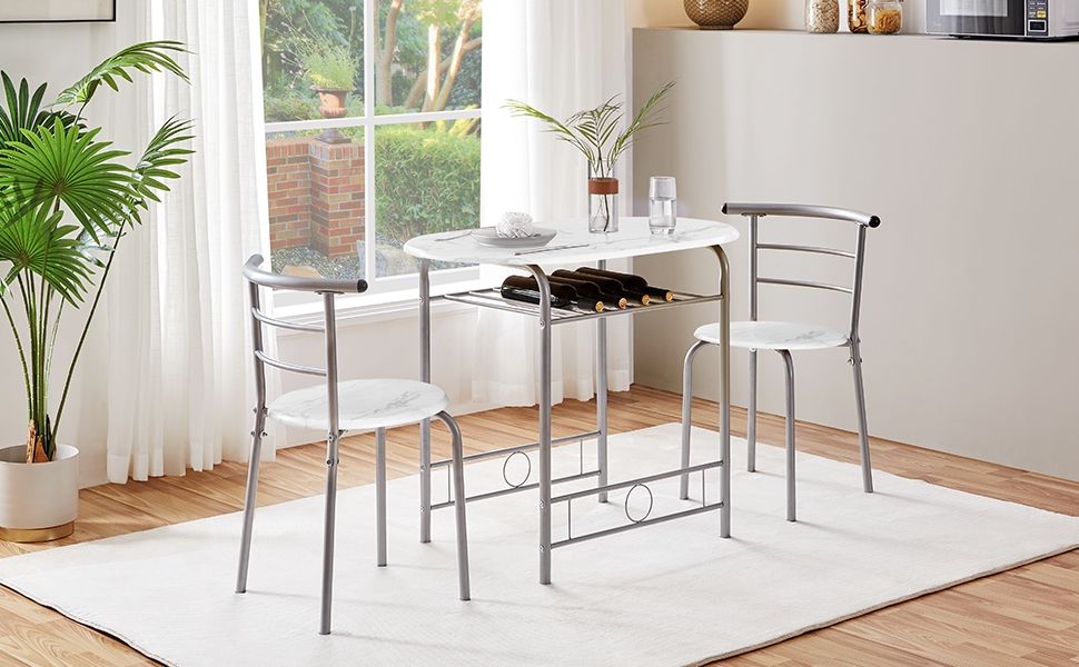 avec table blanche et deux chaises. Structure en métal, plateau en verre et casier à vin intégré en dessous.