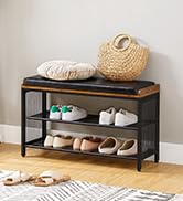 un meuble à chaussures noir avec un banc en bois et un panier avec un panier avec un oreiller dessus.