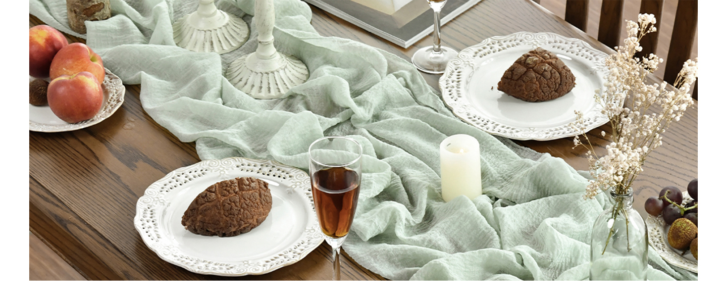 Service de table avec des assiettes blanches contenant une substance poudreuse brune, un verre de liquide foncé et des éléments décoratifs tels qu'un tissu vert clair et des fleurs