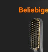 Gros plan d'une brosse à cheveux à poils mélangés dans une palette de couleurs noir et or sur fond