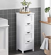 Armoire de rangement de salle de bain en bois blanc avec quatre tiroirs, posée contre un mur carrelé gris. Objets de décoration et plantes sur le dessus et à proximité de l'étagère.