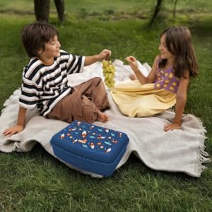 Deux enfants profitant d'un pique-nique avec leur boîte à lunch