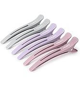 Collection d'outils de toilettage aux couleurs pastel, y compris le rose et le violet, disposés de manière à montrer sous différents angles ce qui semble être des pinces à cheveux ou des accessoires de coiffage.