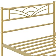 Tête de lit en métal doré avec motif décoratif en forme de soleil et barres de